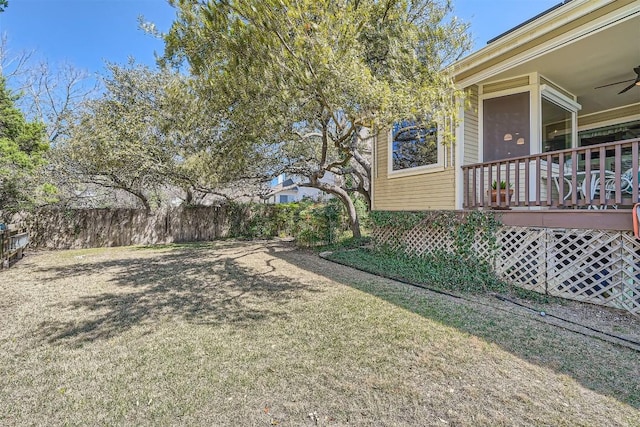 view of yard with a ceiling fan and fence