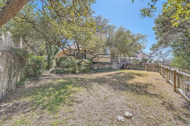 view of yard featuring a wooden deck and a fenced backyard