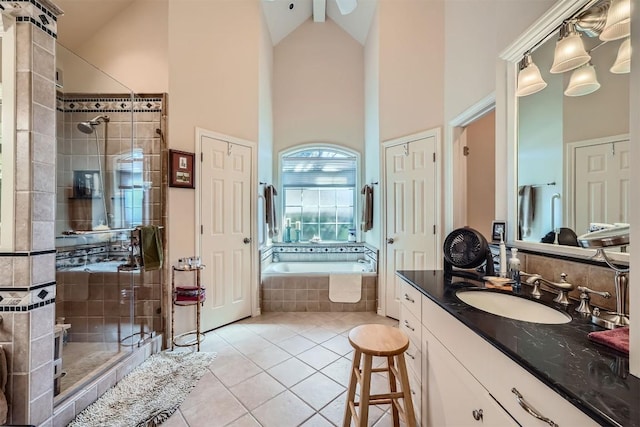 full bath featuring high vaulted ceiling, a stall shower, tile patterned flooring, a bath, and vanity