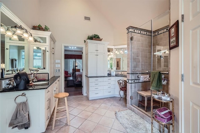 bathroom with visible vents, a stall shower, vanity, and tile patterned flooring