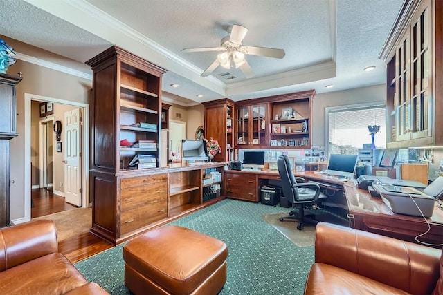 office area featuring a textured ceiling, crown molding, and a tray ceiling