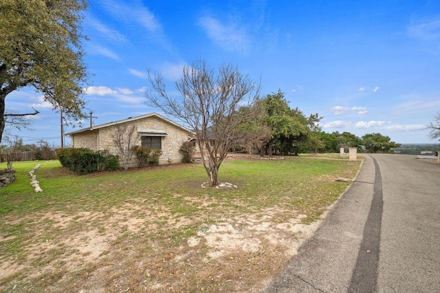 view of property exterior featuring a lawn