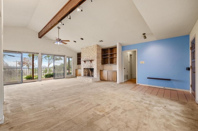 unfurnished living room featuring visible vents, light colored carpet, beamed ceiling, a fireplace, and high vaulted ceiling