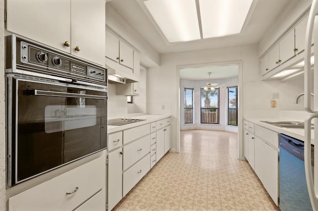 kitchen featuring black appliances, under cabinet range hood, white cabinetry, and light countertops