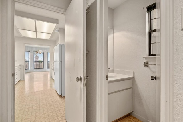 interior space featuring tile patterned floors, baseboards, and vanity