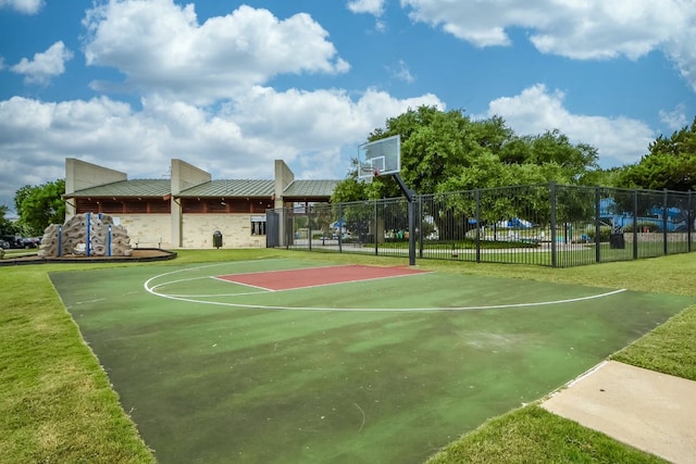 view of sport court featuring community basketball court, fence, and a yard