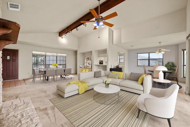 living room with carpet floors, beam ceiling, visible vents, and a healthy amount of sunlight