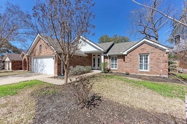 ranch-style house with a garage, driveway, a shingled roof, french doors, and brick siding