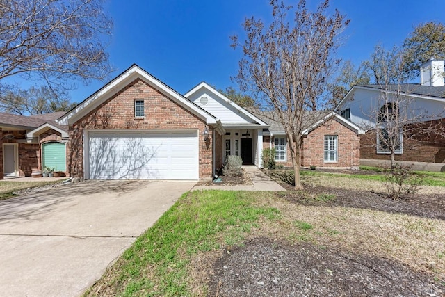 view of front of house featuring a garage, concrete driveway, and brick siding