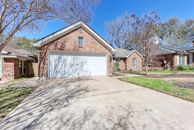 ranch-style home featuring concrete driveway, brick siding, and an attached garage