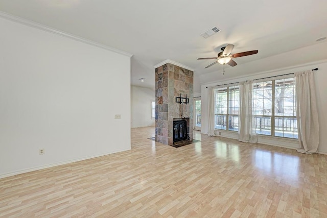 unfurnished living room with crown molding, visible vents, ceiling fan, wood finished floors, and baseboards