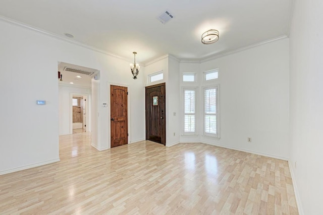 foyer featuring ornamental molding, visible vents, light wood-style flooring, and baseboards