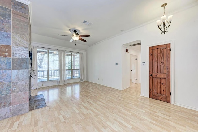 unfurnished living room with crown molding, visible vents, wood finished floors, baseboards, and ceiling fan with notable chandelier