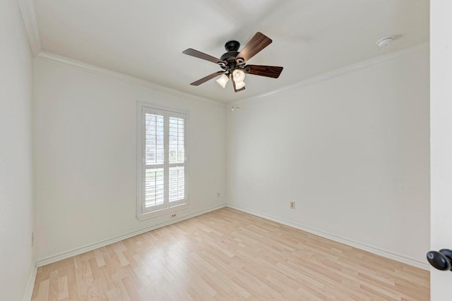 empty room featuring ornamental molding, wood finished floors, a ceiling fan, and baseboards