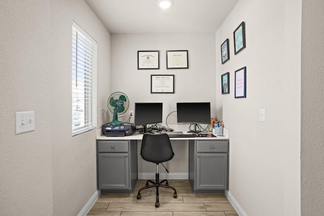 office area with wood finish floors and baseboards