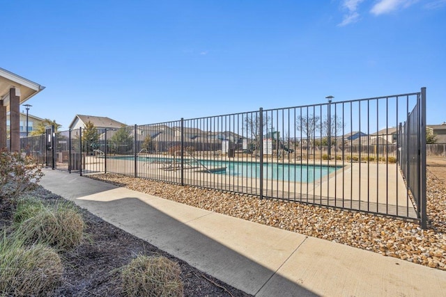 pool featuring fence and a patio