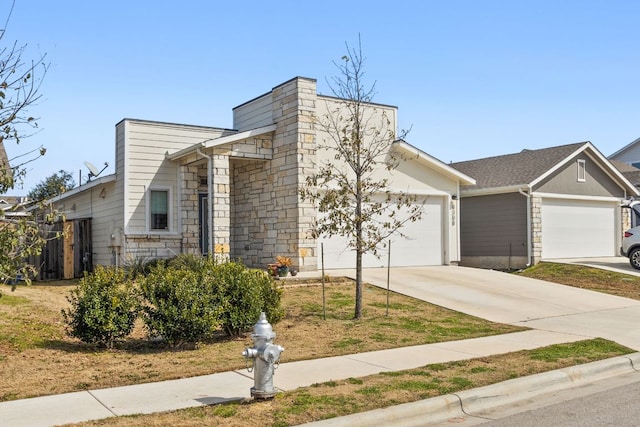 view of front facade with a garage, stone siding, and concrete driveway