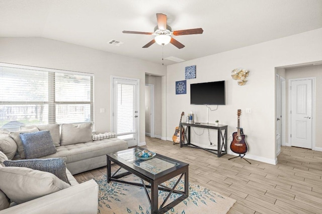 living room with lofted ceiling, visible vents, a ceiling fan, light wood-type flooring, and baseboards