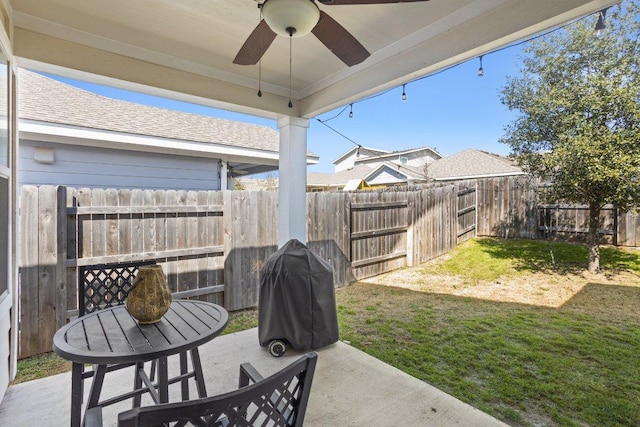 view of yard with ceiling fan, a fenced backyard, and a patio