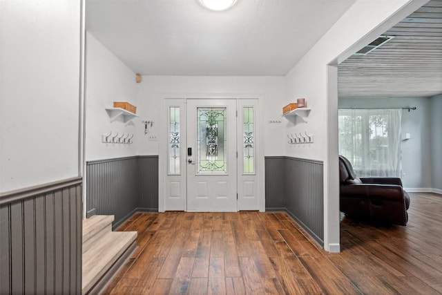 foyer featuring hardwood / wood-style floors and wainscoting