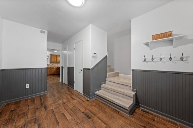 interior space featuring stairway, wainscoting, and wood-type flooring