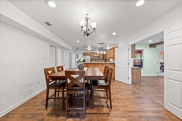 dining space featuring recessed lighting, dark wood-style flooring, visible vents, baseboards, and an inviting chandelier