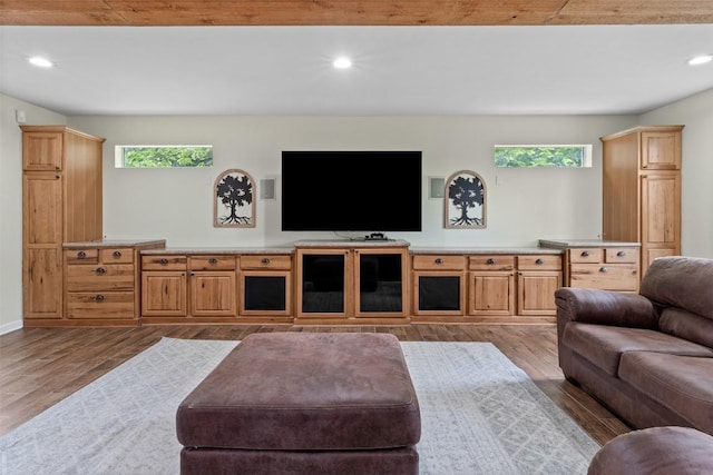 living room with plenty of natural light, wood finished floors, and recessed lighting