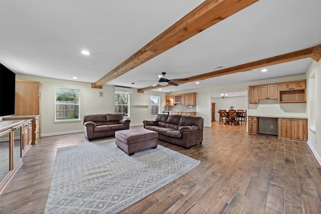 living room with beam ceiling, baseboards, and wood finished floors