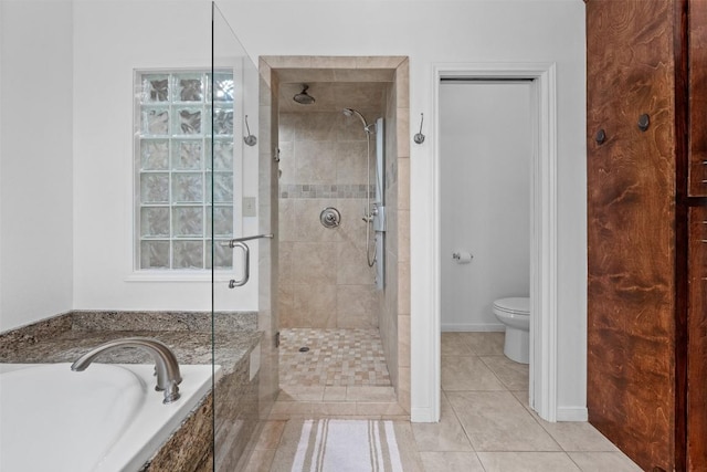 bathroom with toilet, tile patterned flooring, a shower stall, and a bath