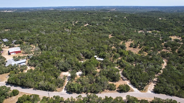 birds eye view of property with a view of trees