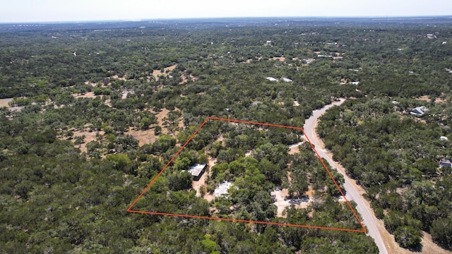 birds eye view of property featuring a wooded view