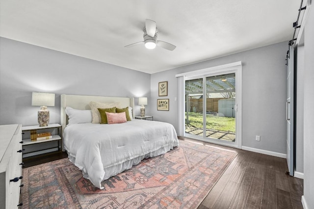 bedroom featuring access to exterior, a barn door, ceiling fan, wood finished floors, and baseboards