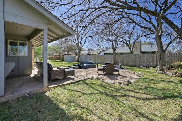 view of yard featuring an outbuilding, a patio area, a fenced backyard, and a storage shed