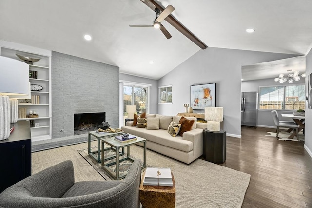 living area featuring baseboards, built in features, hardwood / wood-style floors, vaulted ceiling with beams, and a fireplace