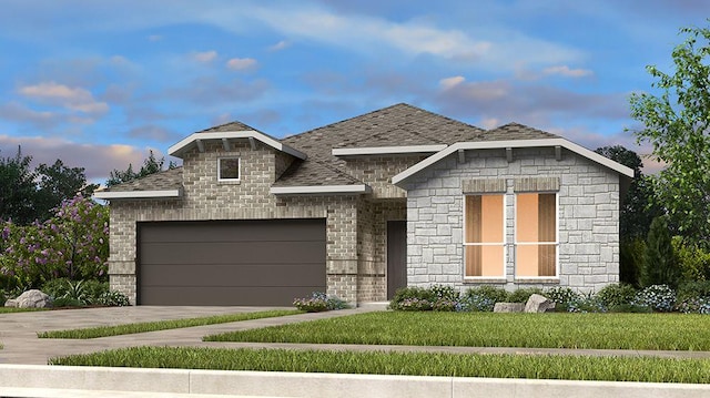 view of front facade featuring a shingled roof, a lawn, concrete driveway, an attached garage, and brick siding