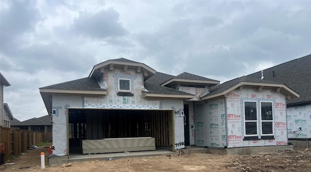 unfinished property featuring a garage and fence