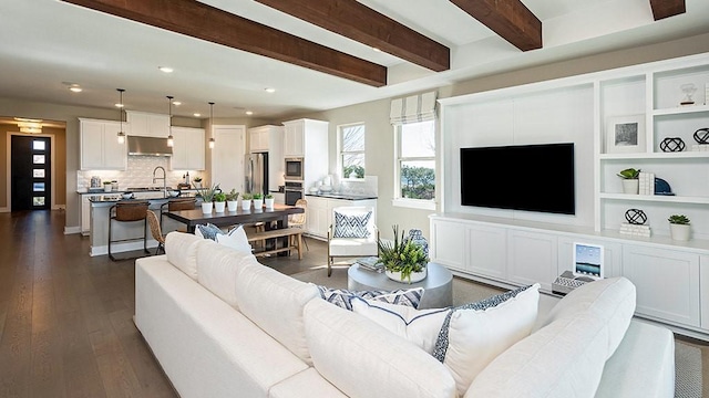 living area with dark wood-style floors, beam ceiling, and recessed lighting