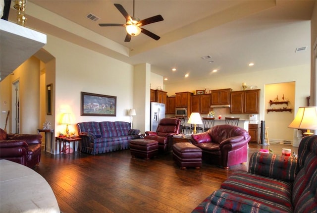 living area featuring ceiling fan, visible vents, dark wood finished floors, and recessed lighting