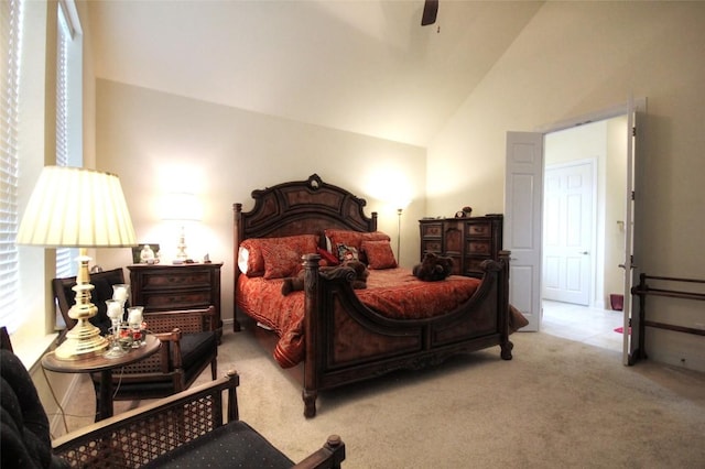 bedroom with ceiling fan, carpet floors, and high vaulted ceiling