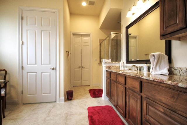 bathroom with visible vents, baseboards, tile patterned floors, vanity, and a shower stall