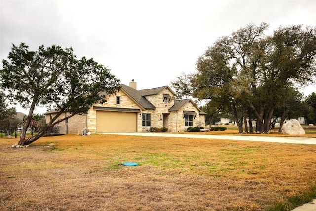 view of front of home featuring stone siding, an attached garage, a chimney, and a front lawn