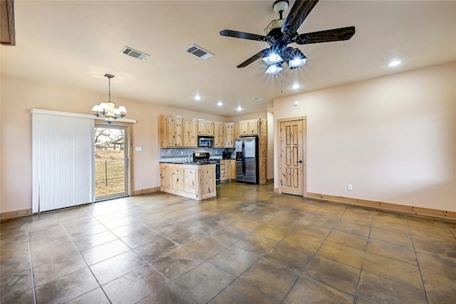 kitchen featuring dark countertops, visible vents, appliances with stainless steel finishes, and light brown cabinetry