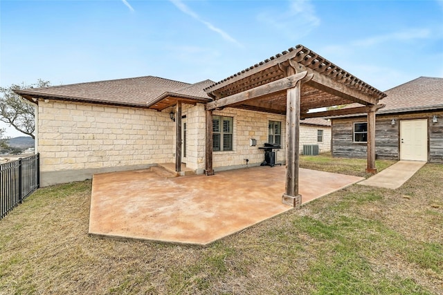 rear view of property featuring a pergola, a lawn, a patio, fence, and central AC