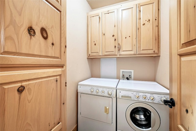 laundry area featuring washing machine and dryer and cabinet space