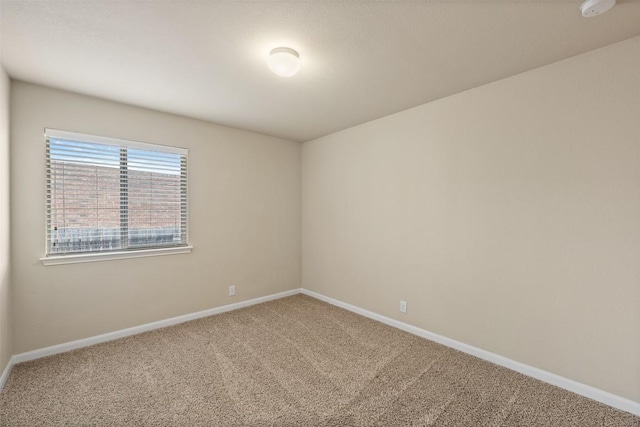 empty room with carpet floors and baseboards