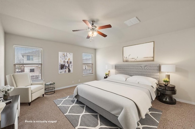 bedroom featuring light carpet, baseboards, visible vents, and a ceiling fan