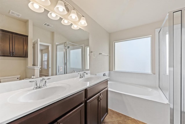 bathroom with toilet, a sink, visible vents, and tile patterned floors