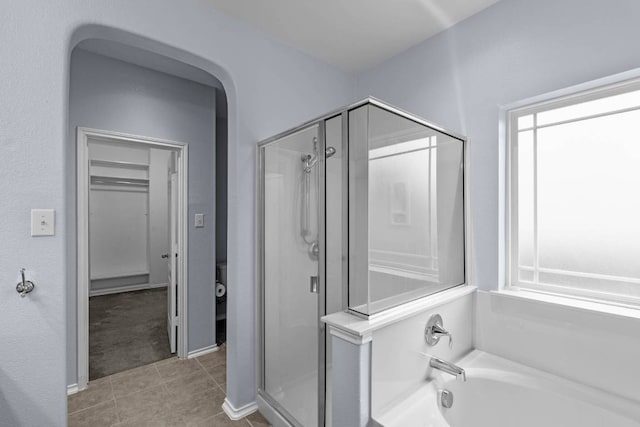 full bath with a stall shower, a garden tub, and tile patterned floors