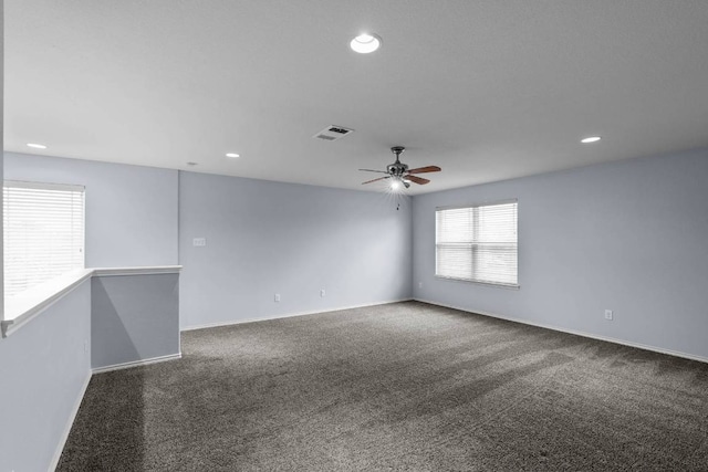 spare room with ceiling fan, recessed lighting, carpet floors, visible vents, and baseboards