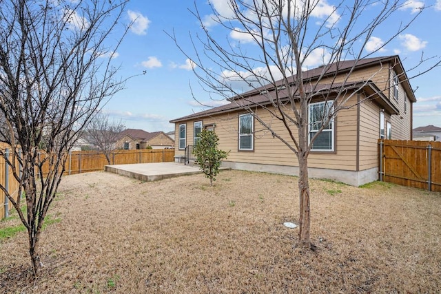 back of property featuring a patio area and a fenced backyard